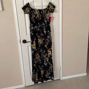 Ladies maxi dress. Black floral with side slit and smocked at the bodice.
